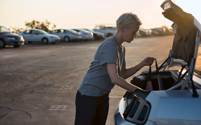 Woman with packaging a car