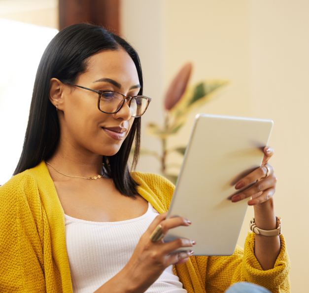 a smiling women looking at her ipad