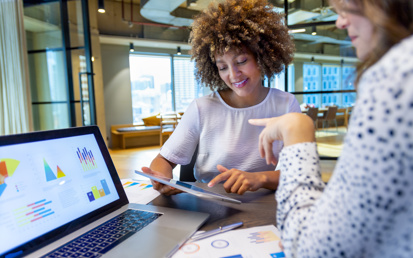 two girls in front of a laptop