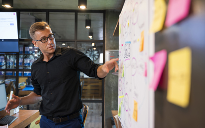 young man in front of a white board