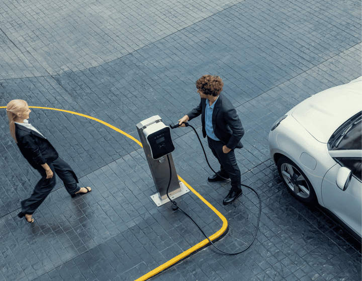 Two drivers prepare to charge their EV vehicle