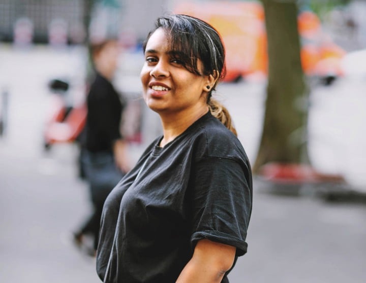 Meera standing in front of a tree