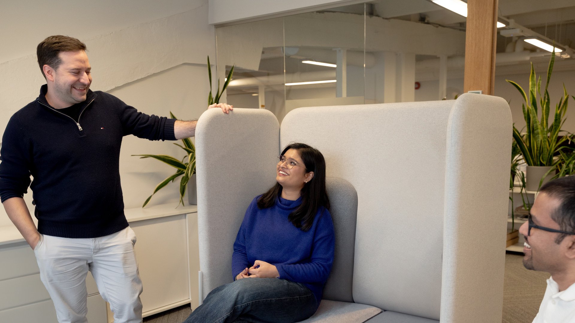 three colleagues in the tallinn office, talking and laughing