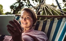 Woman with tablet in a hammock