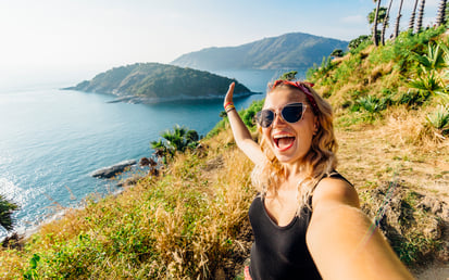 Women on holiday taking a selfie on a mountain