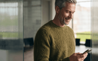 Man smiling looking at his phone