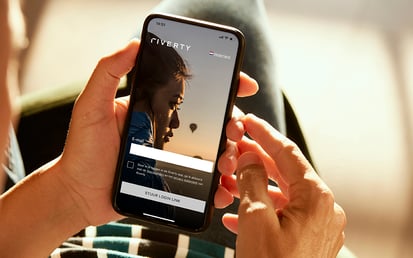 Hand holding a phone with Riverty BNPL App