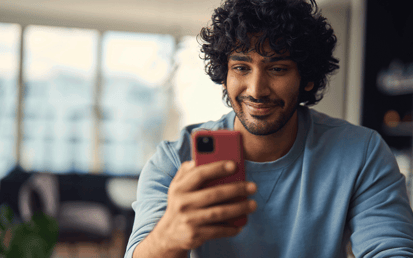 Man smiling at phone