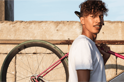 Young man holding his bike