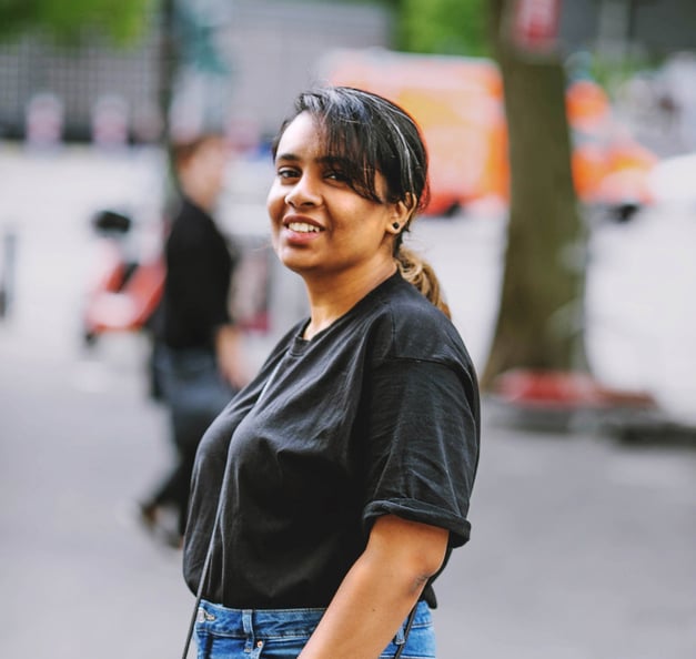 Picture of Meera, standing on the street, looking into the camera