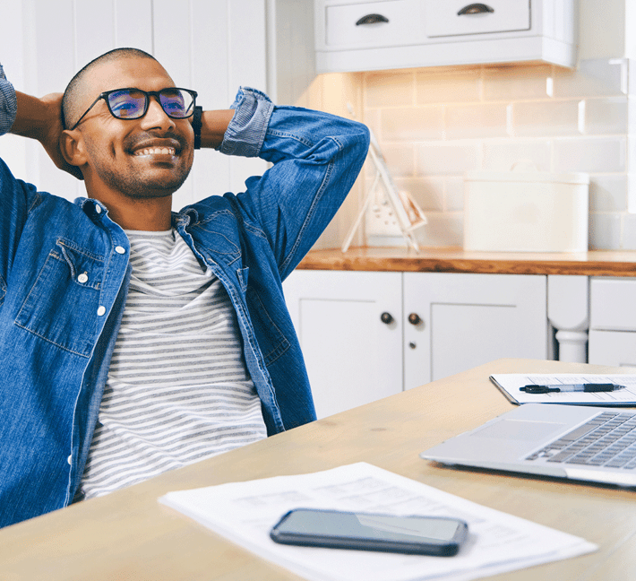 Man is sitting in front of his laptop