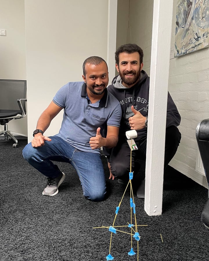 two employees showing their results