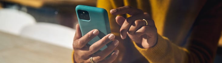 Image showing a smartphone being held with two hands.