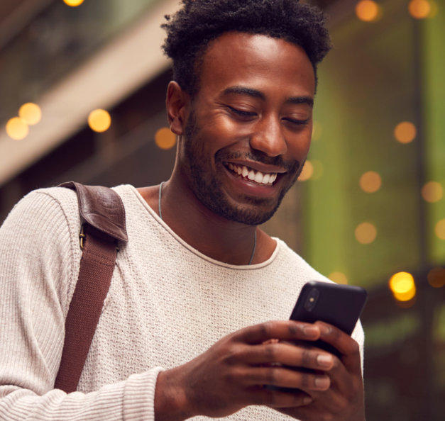 Man holding his phone and smiling