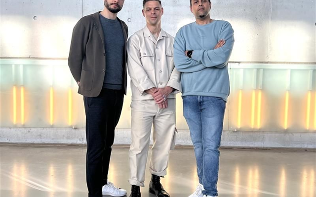Three men from the EV team smiling