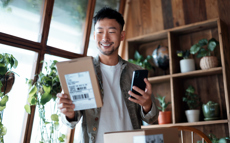 Man smiling at his package.   