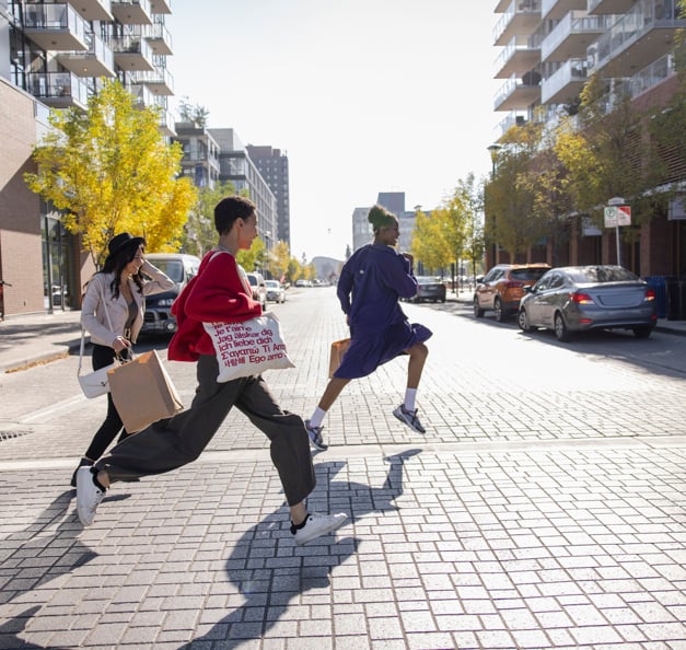 Girls running across the street. 