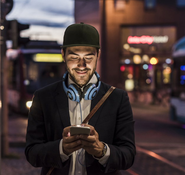 Man with headphones on his phone.