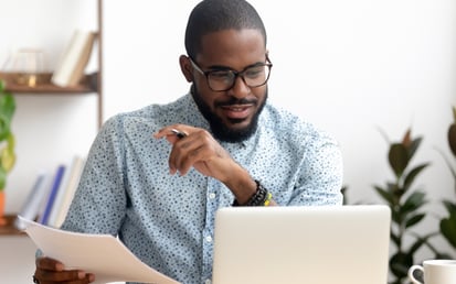 A man sitting next to his computer
